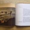 Open pages of Mandurah Surf The Characters and The Coast by Bruce Ellis showing historic surf photography and written stories